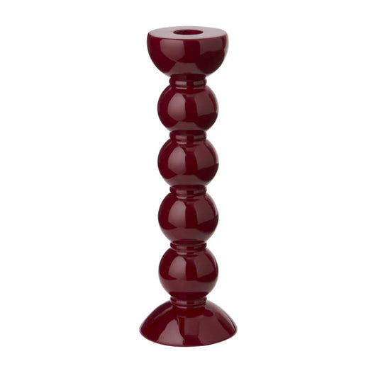 En vinröd ljusstake med härlig bubblig fot mot vit bakgrund. 